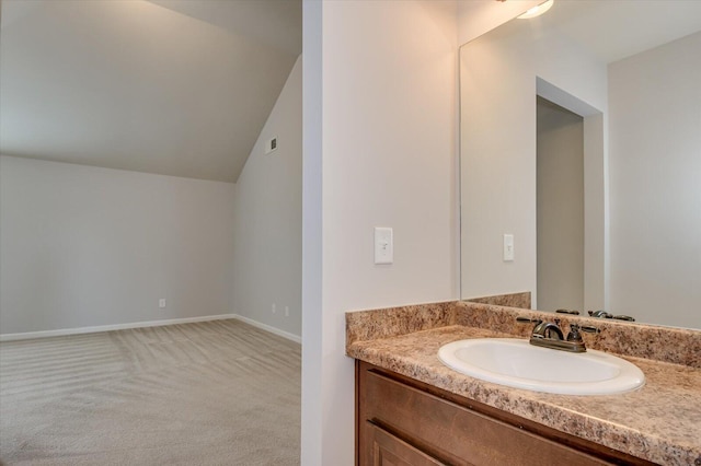 bathroom with vanity and lofted ceiling