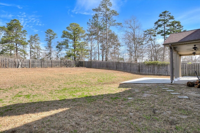 view of yard with ceiling fan and a patio area