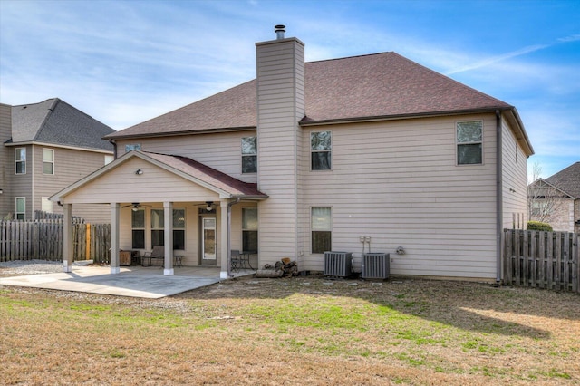 back of house featuring a patio, a lawn, ceiling fan, and central AC unit