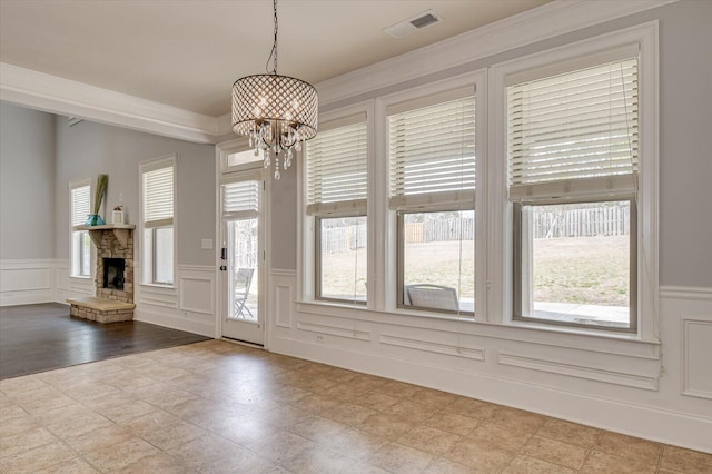 entrance foyer with a fireplace and a chandelier