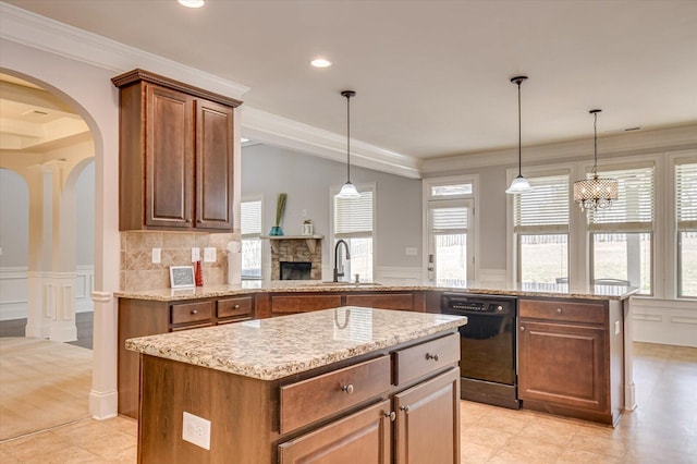 kitchen featuring hanging light fixtures, a center island, sink, and black dishwasher