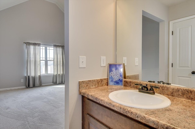 bathroom featuring vanity and lofted ceiling