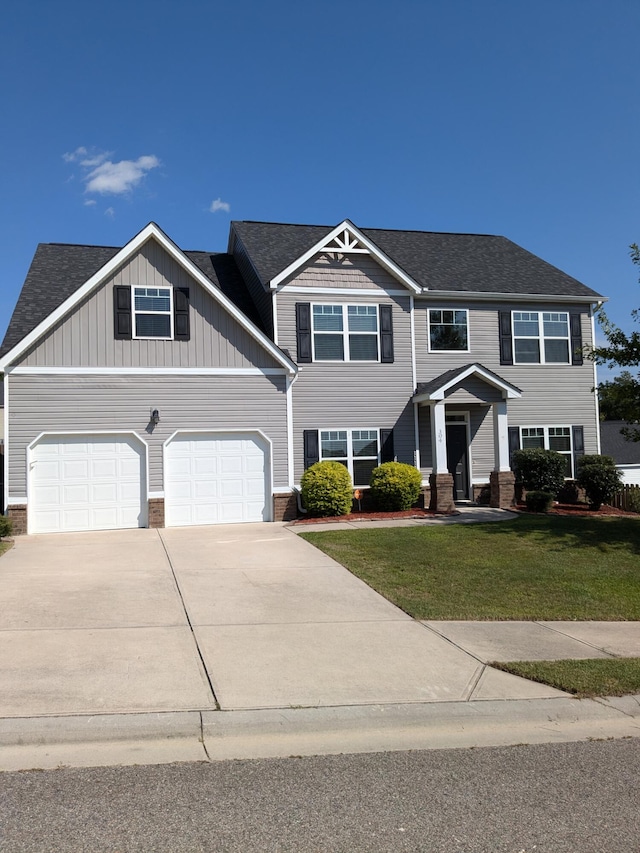 view of front of house featuring a front yard and a garage