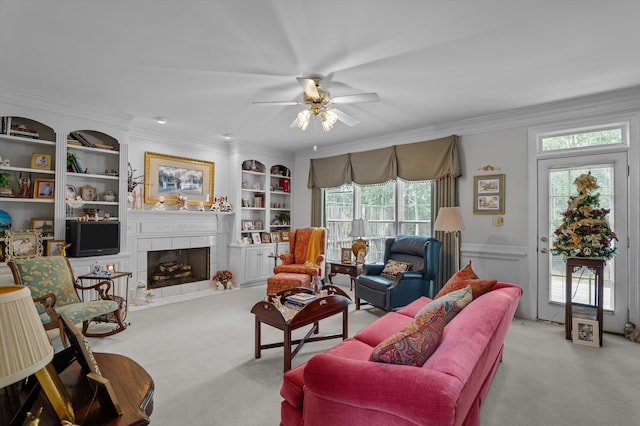 608 Saw Grass Dr, Martinez, GA 30907 - carpeted living room featuring a ceiling fan, a tiled fireplace, crown molding, wainscoting, and built in shelves