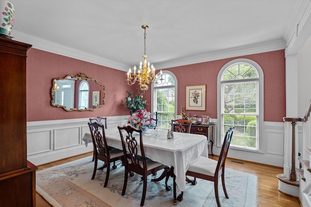 608 Saw Grass Dr, Martinez, GA 30907 - dining space featuring wallpapered walls, light wood finished floors, an inviting chandelier, crown molding, and a wainscoted wall