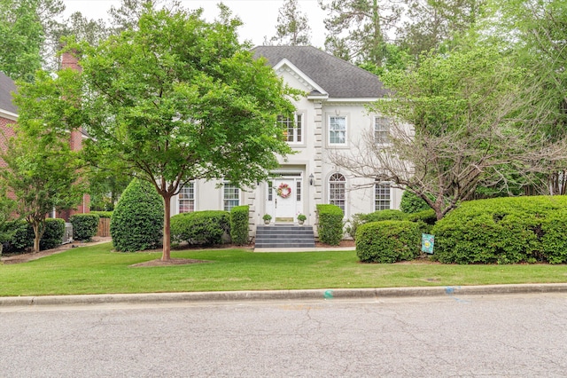 608 Saw Grass Dr, Martinez, GA 30907 - colonial home featuring stucco siding, a shingled roof, and a front lawn