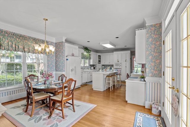 608 Saw Grass Dr, Martinez, GA 30907 - dining room with a healthy amount of sunlight, a chandelier, crown molding, and wallpapered walls