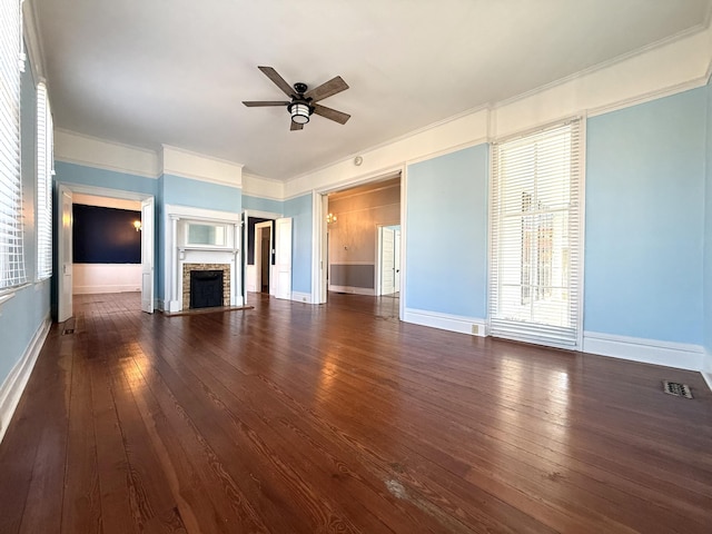 unfurnished living room with ceiling fan, ornamental molding, and dark hardwood / wood-style floors