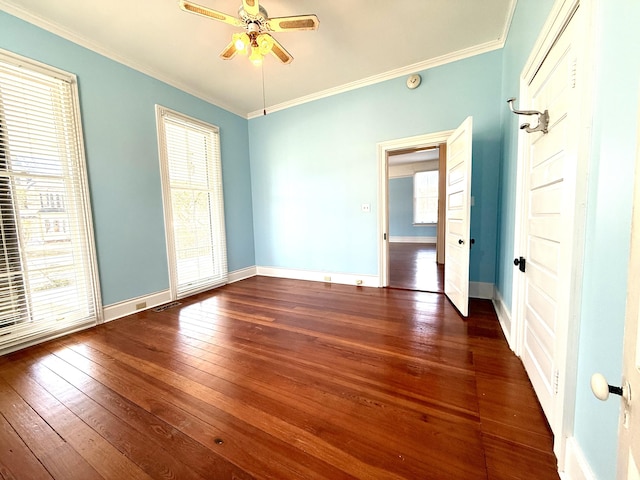 spare room featuring dark hardwood / wood-style flooring, crown molding, and ceiling fan