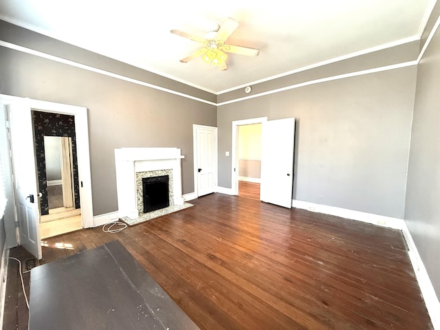 unfurnished living room featuring ceiling fan, ornamental molding, and dark hardwood / wood-style flooring