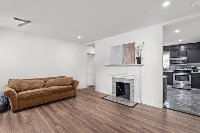 2156 Telfair St, Augusta, GA 30904 - living area featuring recessed lighting, wood finished floors, a stone fireplace, and baseboards