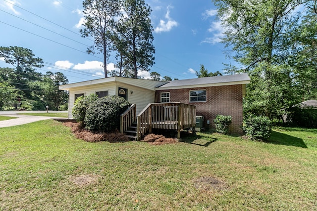 2383 Wheeless Rd, Augusta, GA 30906 - back of property featuring a wooden deck, brick siding, a yard, and concrete driveway