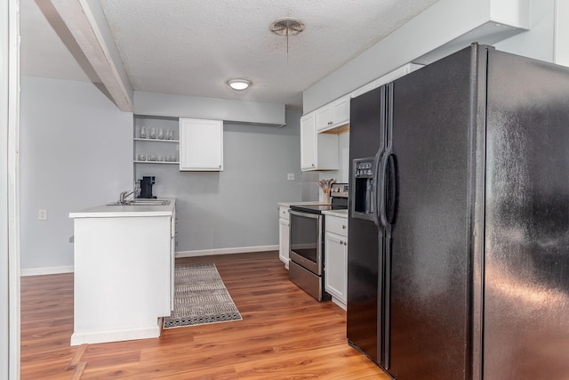 2383 Wheeless Rd, Augusta, GA 30906 - kitchen featuring black fridge, stainless steel range with electric cooktop, open shelves, white cabinets, and light countertops