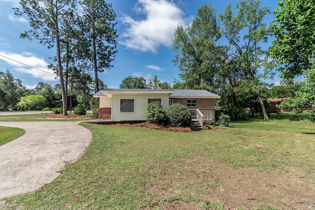 2383 Wheeless Rd, Augusta, GA 30906 - view of front facade featuring brick siding, a front lawn, driveway, and a wooden deck