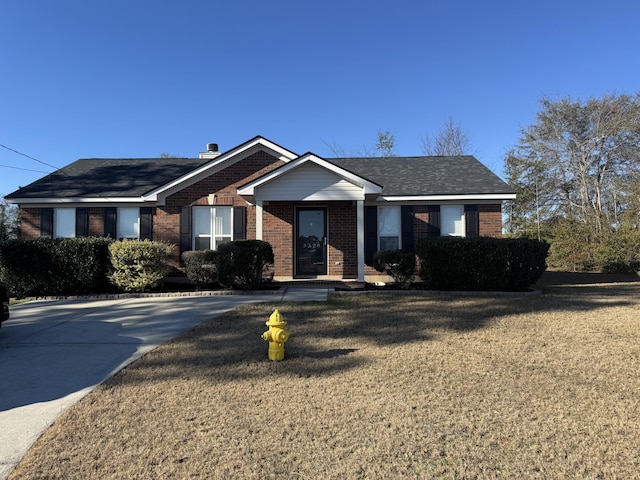 ranch-style home with a front lawn