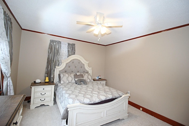 carpeted bedroom featuring ceiling fan and ornamental molding