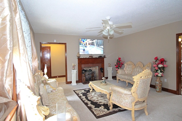 carpeted living room with ceiling fan and a fireplace