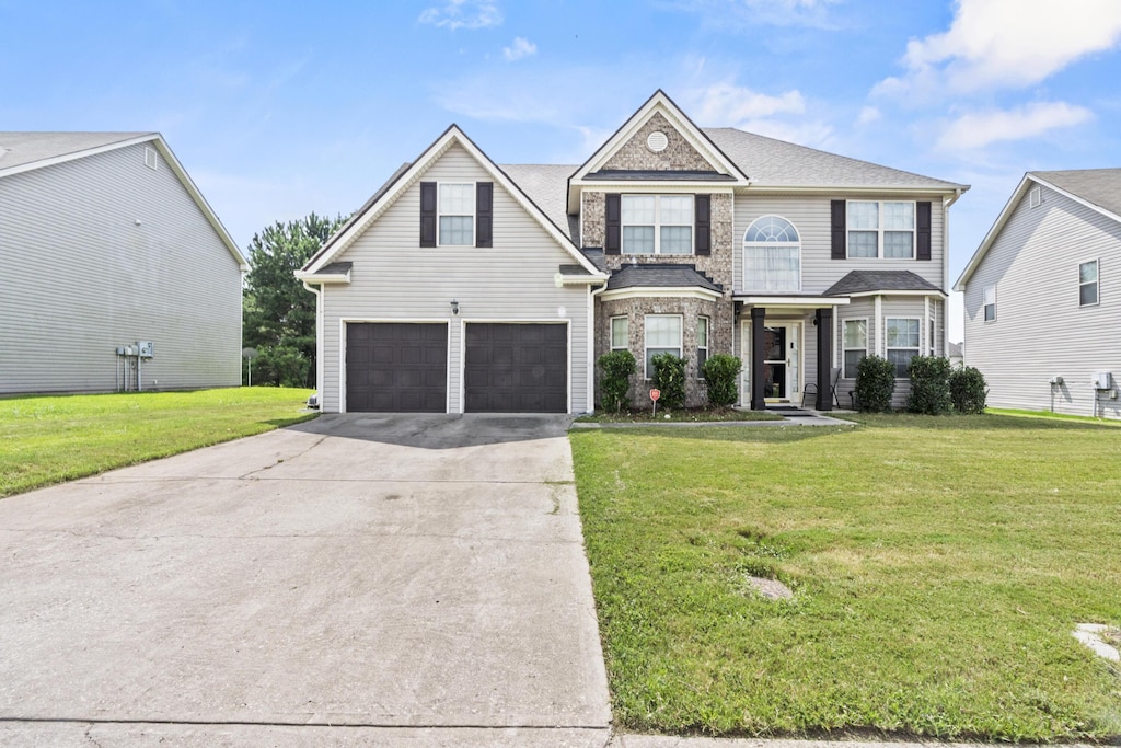 view of front of property with a front yard and a garage