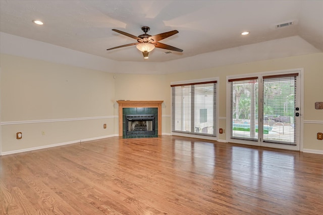 3129 Goolsby Rd, Blythe, GA 30805 - unfurnished living room featuring plenty of natural light, a tile fireplace, a ceiling fan, wood finished floors, and recessed lighting