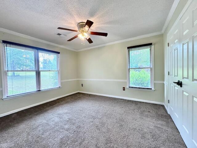 3129 Goolsby Rd, Blythe, GA 30805 - spare room featuring carpet floors, a textured ceiling, ceiling fan, ornamental molding, and baseboards
