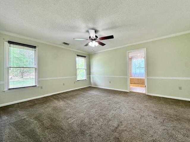 3129 Goolsby Rd, Blythe, GA 30805 - spare room with ornamental molding, ceiling fan, dark colored carpet, a textured ceiling, and baseboards
