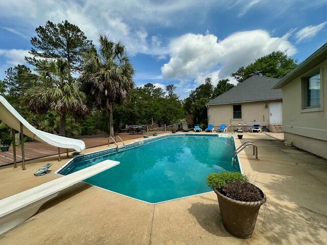 3129 Goolsby Rd, Blythe, GA 30805 - swimming pool featuring a water slide, a diving board, and a patio