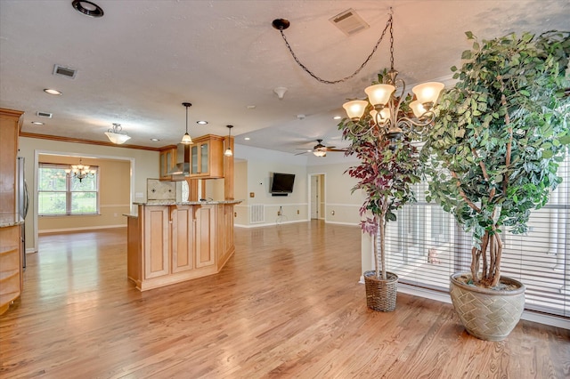 3129 Goolsby Rd, Blythe, GA 30805 - kitchen with a chandelier, ceiling fan, light wood-style flooring, glass insert cabinets, and crown molding