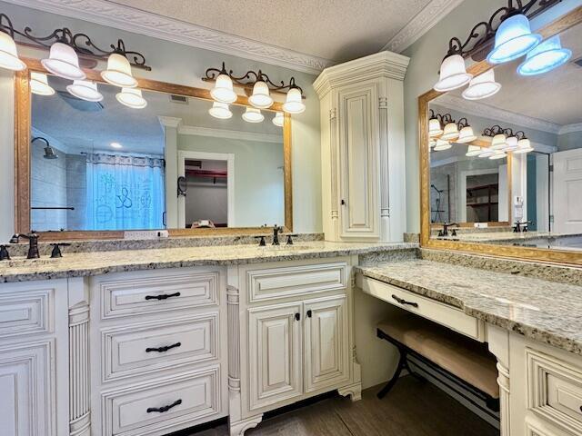 3129 Goolsby Rd, Blythe, GA 30805 - bathroom featuring ornamental molding, a shower, double vanity, wood finished floors, and a textured ceiling