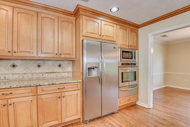 3129 Goolsby Rd, Blythe, GA 30805 - kitchen with stainless steel appliances, a warming drawer, decorative backsplash, light wood-style flooring, and light stone countertops