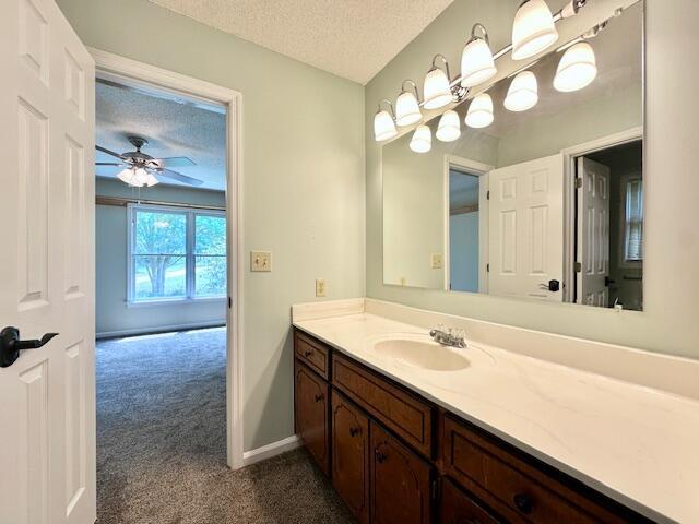 3129 Goolsby Rd, Blythe, GA 30805 - bathroom featuring vanity, ceiling fan, a textured ceiling, and baseboards