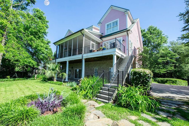 114 Altamaha Dr, North Augusta, SC 29841 - view of front of home featuring stairway, a sunroom, a front lawn, and brick siding