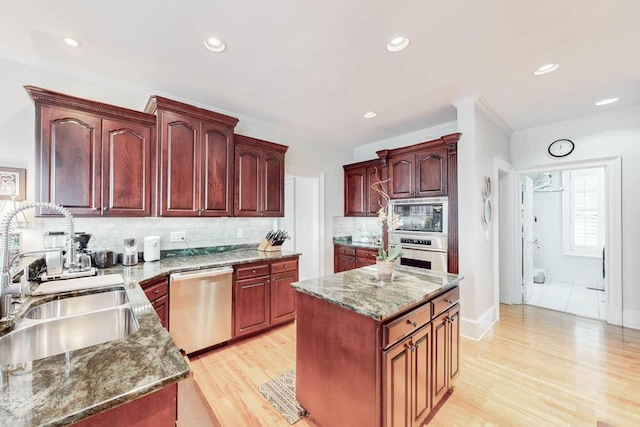 114 Altamaha Dr, North Augusta, SC 29841 - kitchen with appliances with stainless steel finishes, a sink, reddish brown cabinets, decorative backsplash, and light wood-style floors