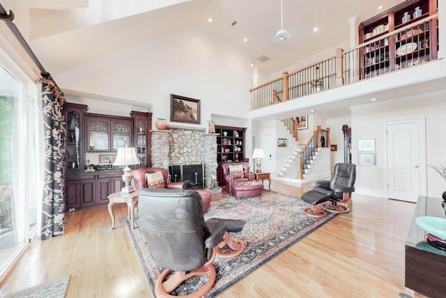 114 Altamaha Dr, North Augusta, SC 29841 - living area featuring high vaulted ceiling, a fireplace, light wood-type flooring, stairway, and recessed lighting