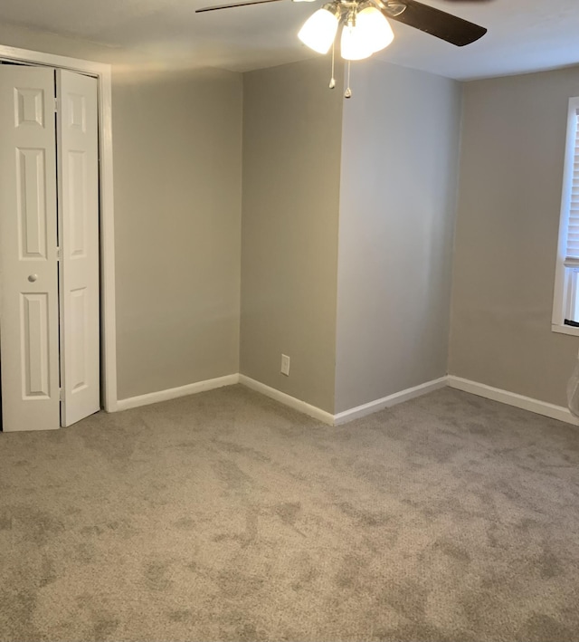 empty room featuring carpet and ceiling fan