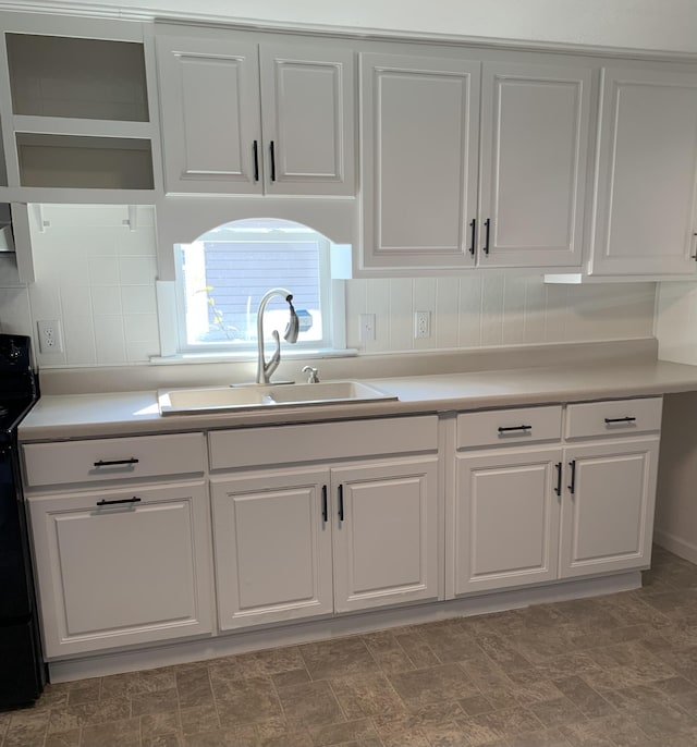 kitchen featuring white cabinetry, sink, and electric range