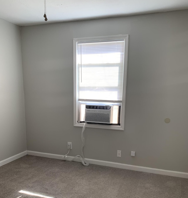 empty room featuring cooling unit and carpet flooring