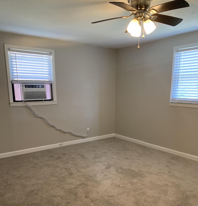 spare room with cooling unit, ceiling fan, and carpet floors