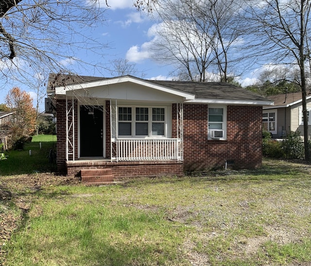 view of front of home with a porch and a front lawn