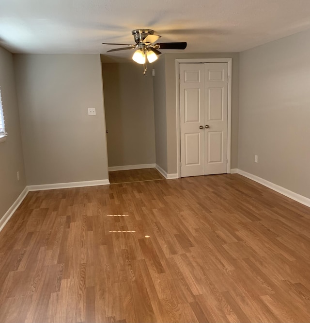 unfurnished room featuring ceiling fan and light wood-type flooring