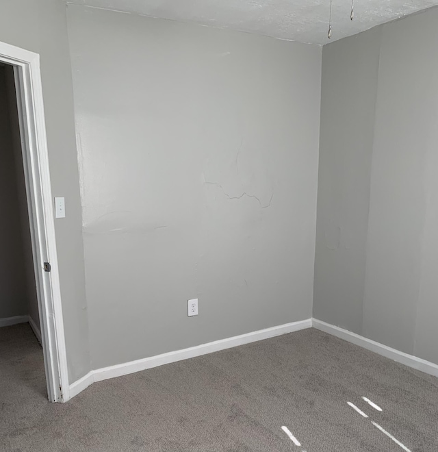 empty room featuring carpet flooring and a textured ceiling