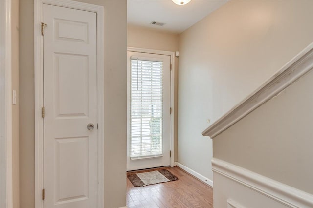 doorway featuring a healthy amount of sunlight and light hardwood / wood-style flooring