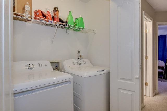 laundry room featuring washer and dryer and light colored carpet