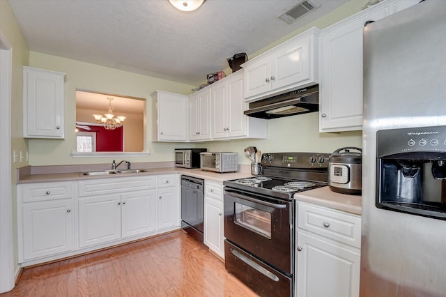 kitchen with sink, white cabinets, light hardwood / wood-style floors, black appliances, and an inviting chandelier