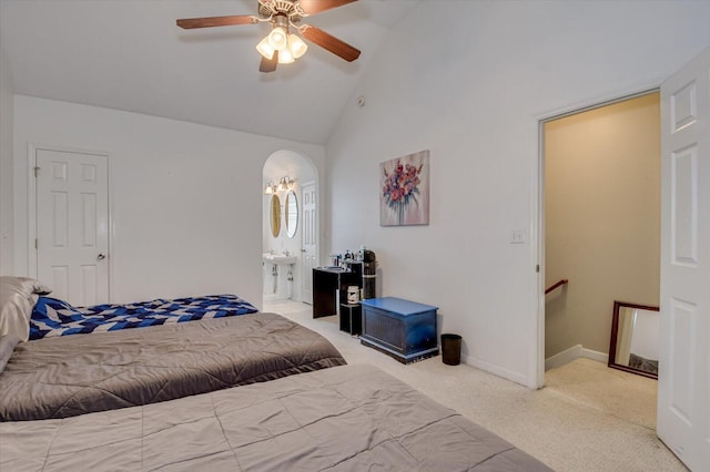 carpeted bedroom with ceiling fan, ensuite bath, and lofted ceiling