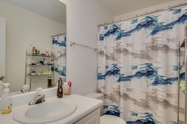 bathroom featuring vanity, a shower with curtain, and toilet