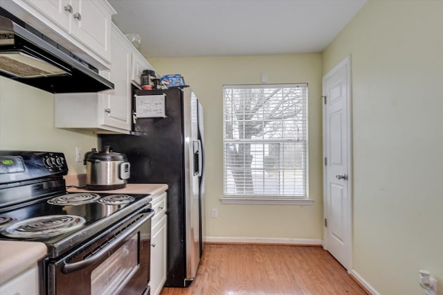 kitchen featuring white cabinetry, ventilation hood, electric range, a wealth of natural light, and light hardwood / wood-style floors