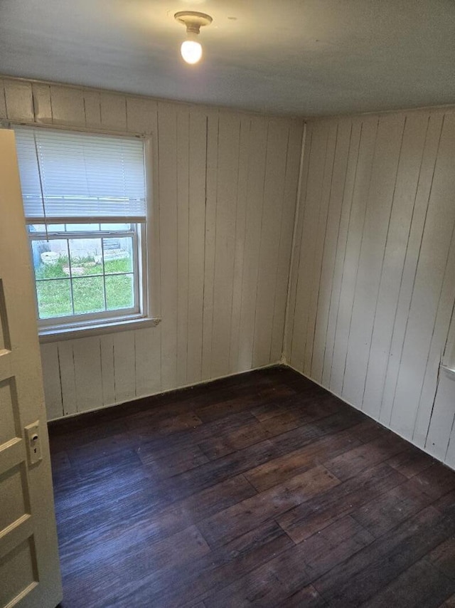 213 Whitehead St, Thomson, GA 30824 - empty room with dark wood-style floors and wooden walls