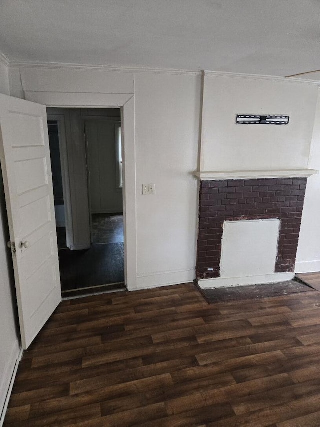 213 Whitehead St, Thomson, GA 30824 - unfurnished living room with wood finished floors, ornamental molding, a fireplace, and baseboards
