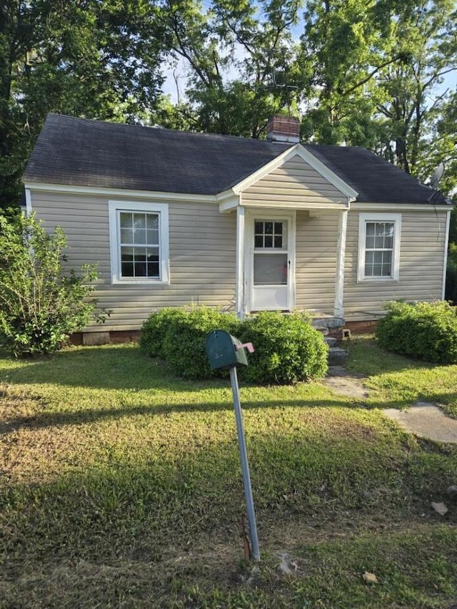 213 Whitehead St, Thomson, GA 30824 - view of front of home with a chimney and a front lawn