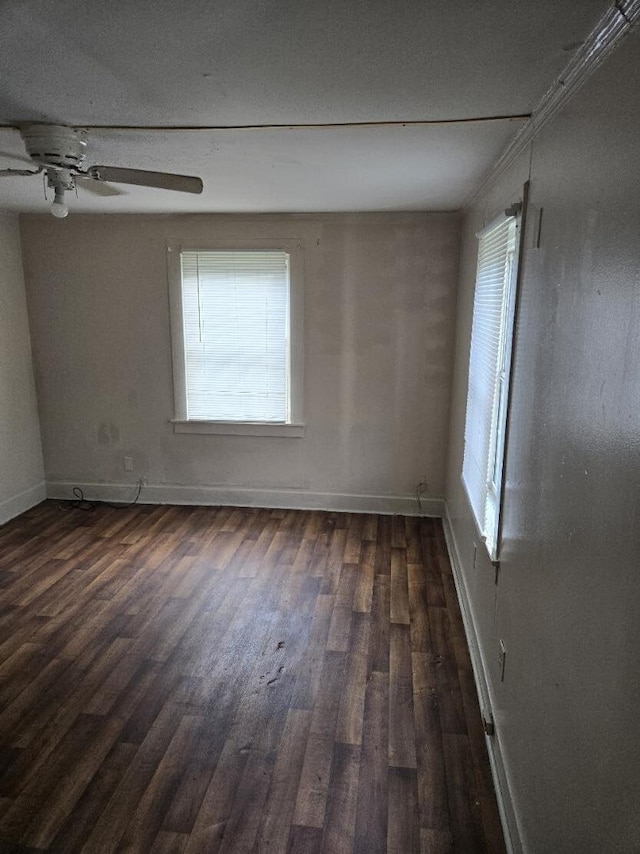 213 Whitehead St, Thomson, GA 30824 - empty room with dark wood-style floors, baseboards, and a ceiling fan